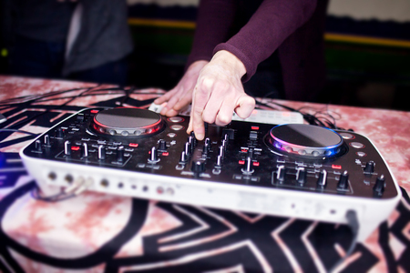 DJ mixing music on console at the night club.の写真素材