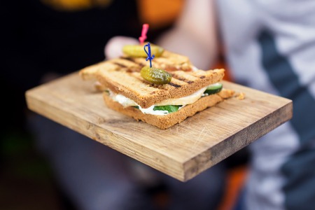 Fresh and tasty sandwich with ham and vegetables on wooden board.の写真素材