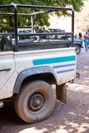 Close-up photo of white old suv at the off-road.