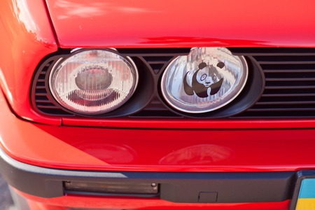 KYIV, UKRAINE - August 7, 2017: WWF logo on red old retro car headlight.のeditorial素材