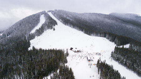 Aerial view of the ski slope in the mountains where skiers ride
