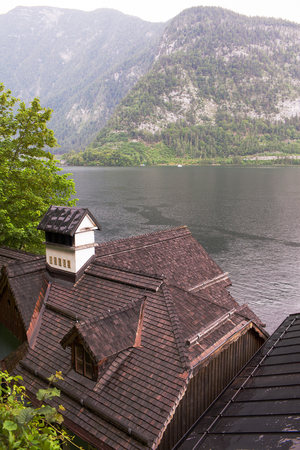 Old vintage wooden roofs of houses by the lake in Hallstatt, Austria.の写真素材