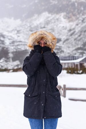 A young girl looks at the camera on the background of a theater with snow.の写真素材