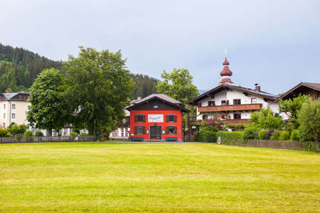 Lofer, Austria - May 25, 2018: An old, vintage, red, teatre, wooden house is located in the Alps.のeditorial素材