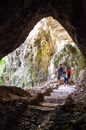 Plitvice Lakes, Croatia: September 23 2018: Elderly man and woman explore the cave.