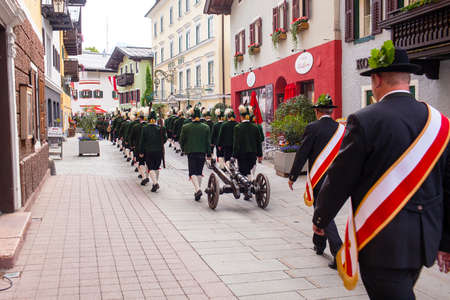 Lofer, Austria - May 31, 2018: Military parade in national costumes with gun and weapon.のeditorial素材
