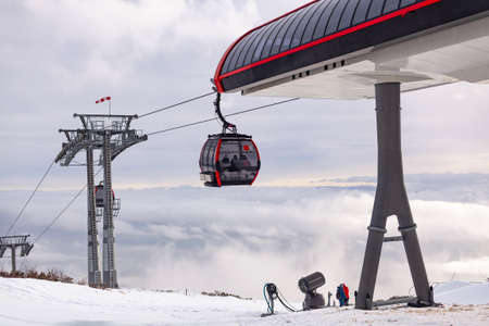 Cableway cabin above the clouds at sunsetの写真素材