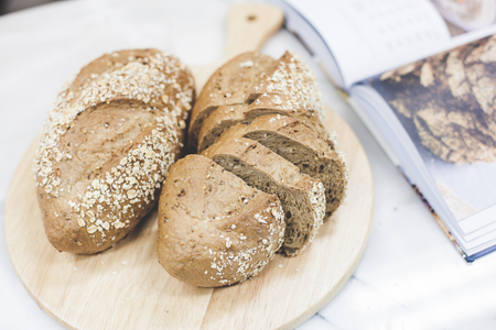 slices of freshly baked multigrain bread on rustic backgroundの写真素材
