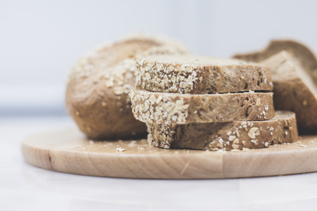 slices of freshly baked multigrain bread on rustic backgroundの写真素材
