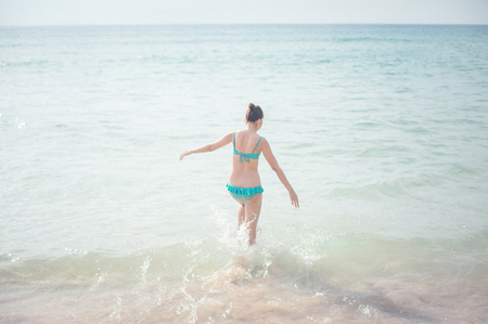 a lady running at the paradise beach horizontalの写真素材