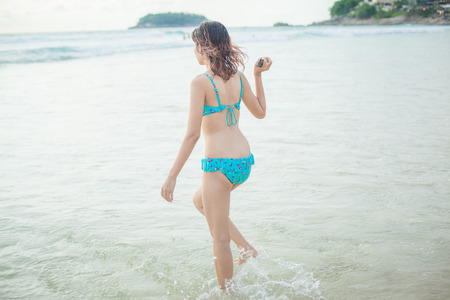 a lady walking at the paradise beach horizontalの写真素材