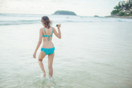 a lady walking at the paradise beach horizontalの写真素材