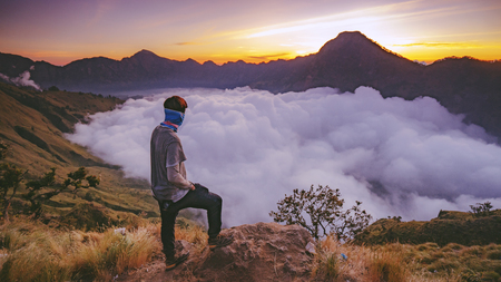 The man was relaxing and proud to success to arrive at Rinjani basecampの写真素材