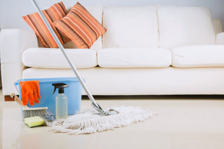 Collection of cleaning products and tools in living roomの写真素材