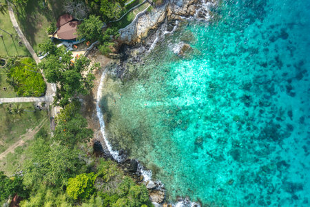 Top down aerial view of a clean white sandy beach on the shores of a beautiful turquoise seaの写真素材