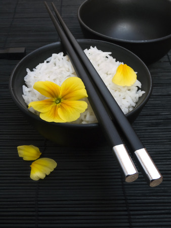 asian rice with yellow flower and chopsticksの写真素材