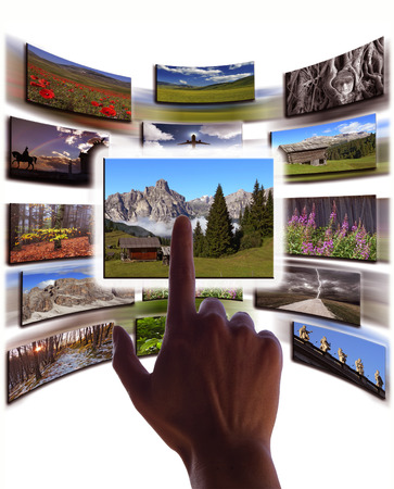 hand and pictures collage on touchscreenの写真素材