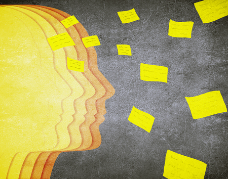 colored human head silhouette and flying post it memory conceptの写真素材