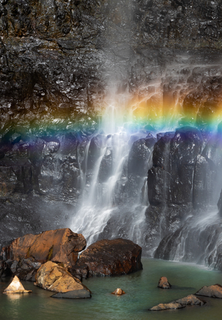 A rainbow across the waterfallの写真素材