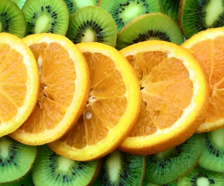 a lot of pieces kiwi fruit and an orange, a backgroundの写真素材