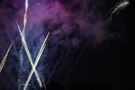 Explosive and colorful holiday fireworks at night sky. Celebration City Holiday. Pyrotechnic smoke and bright flashesの写真素材