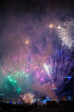 Minsk, Belarus -January 1, 2019: Explosive and colorful holiday fireworks at night sky. Celebration City Holiday. Pyrotechnic smoke and bright flashesのeditorial素材