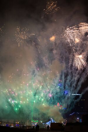 Minsk, Belarus -January 1, 2019: Explosive and colorful holiday fireworks at night sky. Celebration City Holiday. Pyrotechnic smoke and bright flashesのeditorial素材