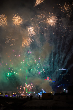 Minsk, Belarus -January 1, 2019: Explosive and colorful holiday fireworks at night sky. Celebration...