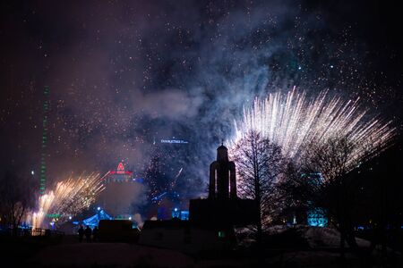 Minsk, Belarus -January 1, 2019: Explosive and colorful holiday fireworks at night sky. Celebration City Holiday. Pyrotechnic smoke and bright flashesのeditorial素材