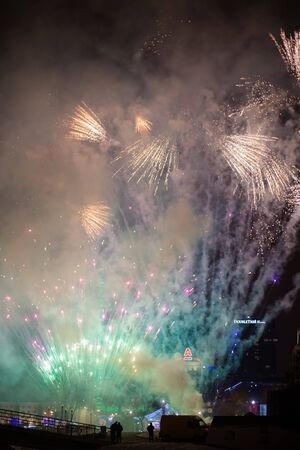 Minsk, Belarus -January 1, 2019: Explosive and colorful holiday fireworks at night sky. Celebration City Holiday. Pyrotechnic smoke and bright flashesのeditorial素材