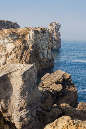 Papoa cliffs and Atlantic ocean in Peniche. Beautiful rocks blue sky and sea. Portugal