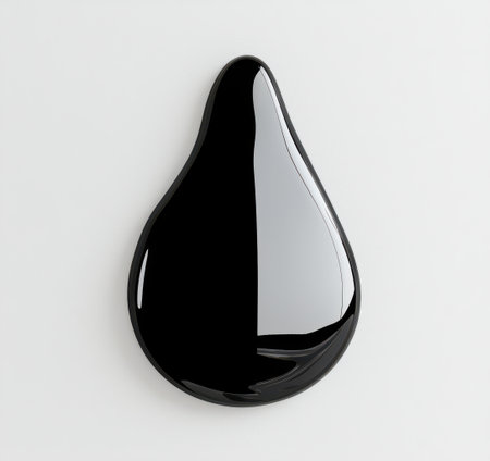 Black oil drop with a glossy surface casting a subtle shadow on a pure white background, showcasing a smooth texture and reflecting light with a subtle gradientの素材