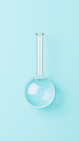 Clear glass flask filled with a light blue liquid sits on a matching blue background, small bubbles clinging to the inside surface of the glassの素材