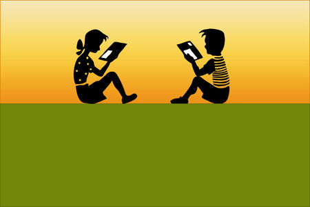The boy and the girl together sit and readの写真素材