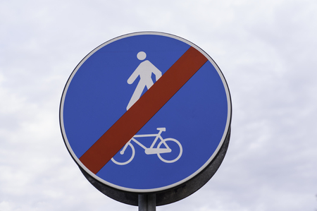End of route cycle lane and pedestrians road sign circular, dodger blue, with a red slashの写真素材