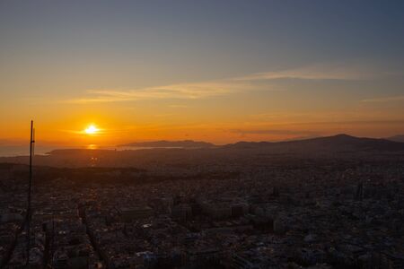 Sunset in Athens on a cloudy sky with a city view from Lycabettus hill in Athens Greeceの写真素材