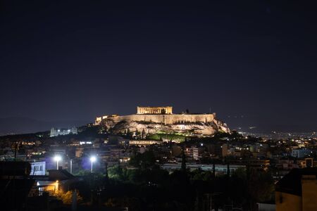 Night view of acropolis building on a hill with lights and beautiful scenery in Athensの写真素材