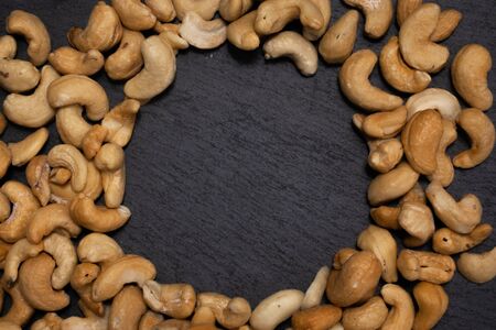 Salted cashew nuts on a black background.の写真素材