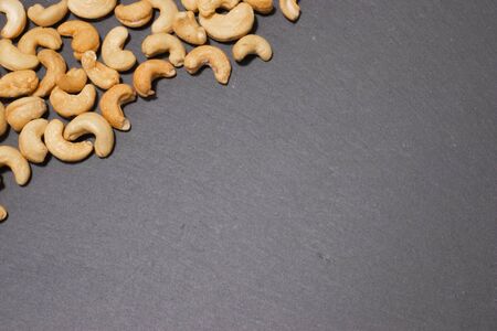 Salted cashew nuts on a black background.の写真素材