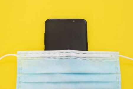 Surgical mask with rubber ear straps. Typical 3-ply surgical mask, masks pff2 and pff3 against covid.の写真素材