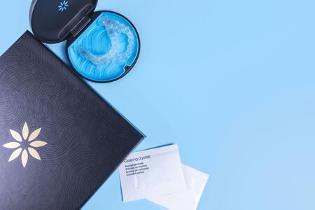 Invisible transparent aligners invisalign blue package with a box, clear-plastic retainers and cleaning crystals. With copyspace for banners and websitesの写真素材