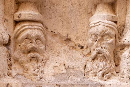 VALENCIA, SPAIN - JULY 15, 2020: Head bas-relief of an ancient gothic cathedral in Valenciaのeditorial素材