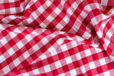 Traditional white and red kitchen chekered towel rustic style for a picnic or tablecloth with tartan pattern. Gingham crampled texture for table napkinの写真素材