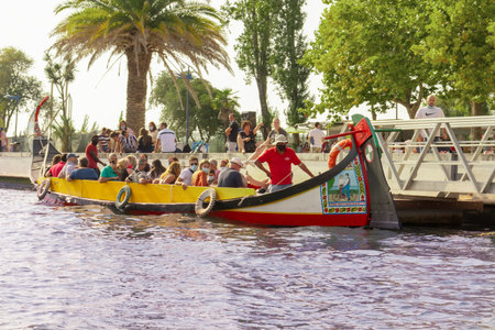 AVEIRO, PORTUGAL - AUGUST 26, 2021: Traditional colourful Moliceiro boats at the canal in Aveiro, Portugalのeditorial素材