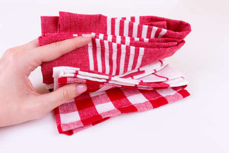 Caucasian woman holding several classic red plaid kitchen towels or picnic tableclothの写真素材