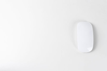 White wireless mouse on white backgroung, copy space