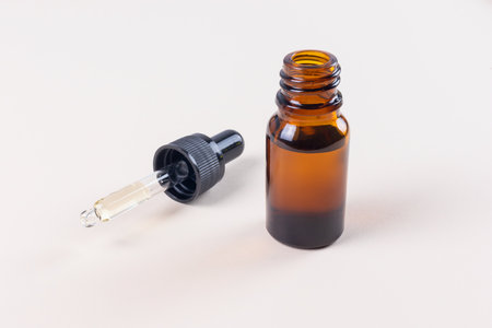 Small open Brown Bottle Eye Dropper Mock-Up with pipette and black lidの写真素材