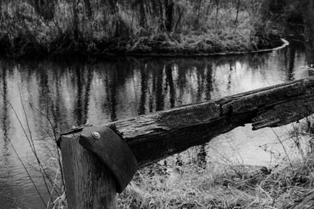 Wooden fence post of rusty metal and water nearbyの写真素材