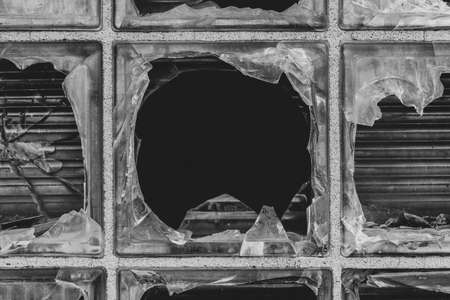 Broken glass block window with flat black centerの写真素材