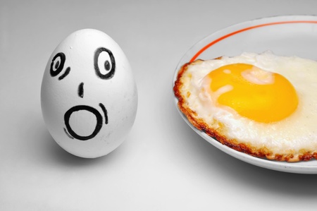 Egg with surprise looks at fried eggs; amusing advertising of a food and a dietの写真素材